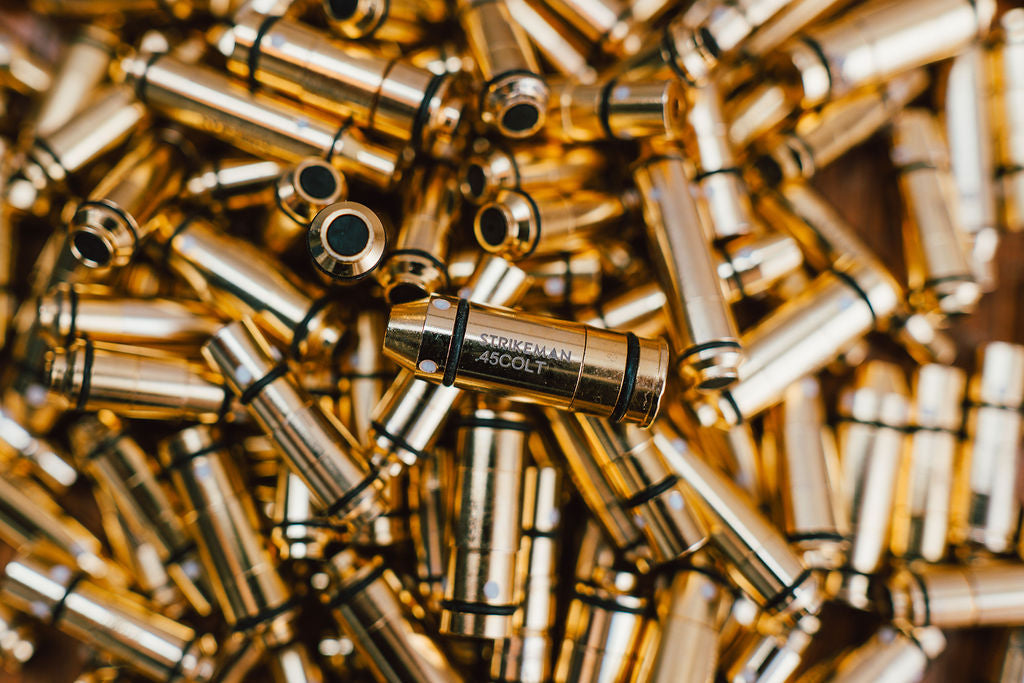 Close-up of Strikeman laser cartridges among brass casings